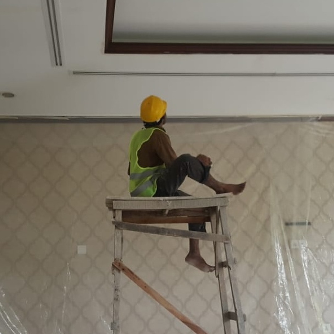 Painter inspecting the ceiling paint